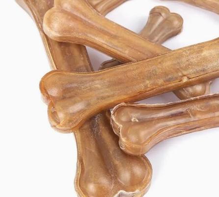 機械、ペット フードのプロセス用機器を作る軽食の犬用の骨をかみ砕いている犬